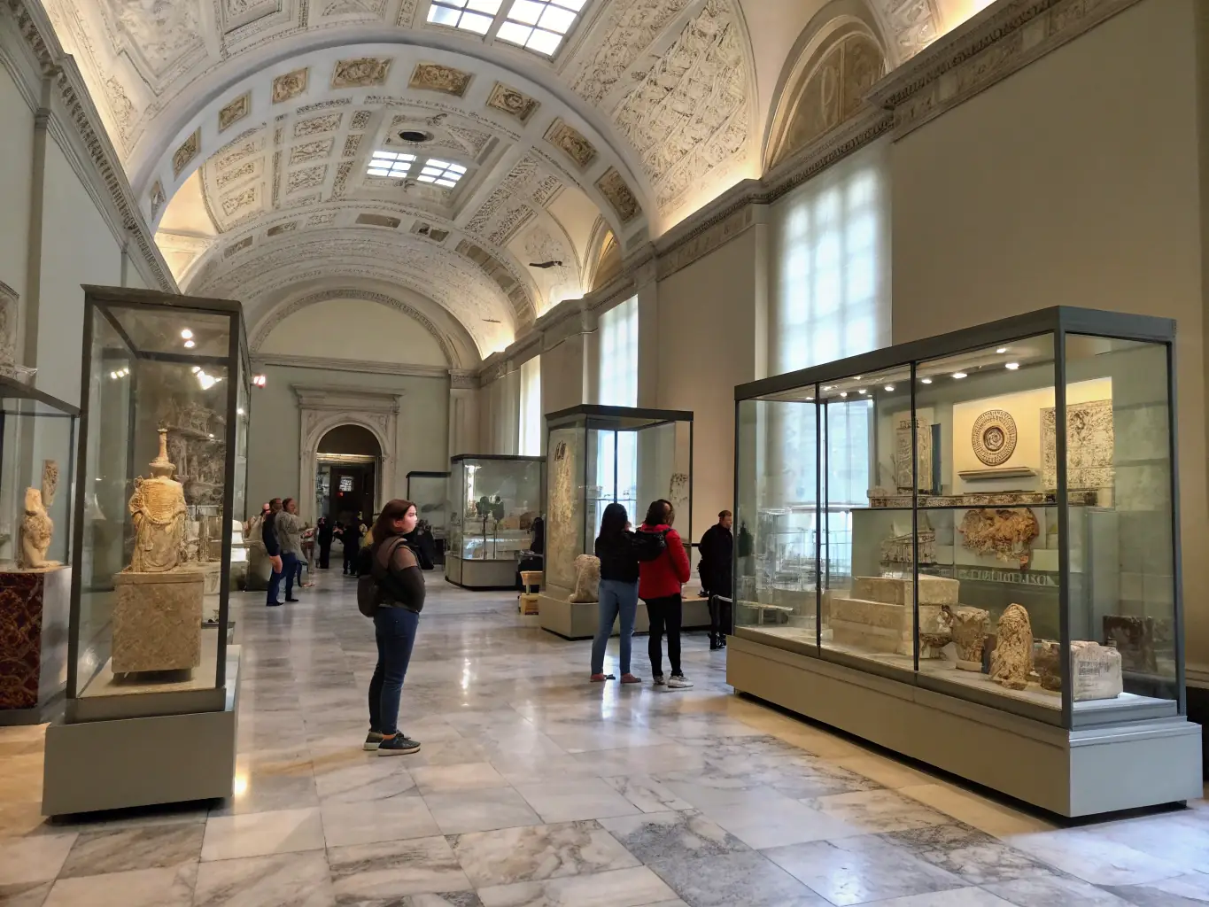 A photograph of a historical exhibition at LES TRESORS DE LISETTE, showcasing artifacts from the 1900s, with visitors observing the displays.